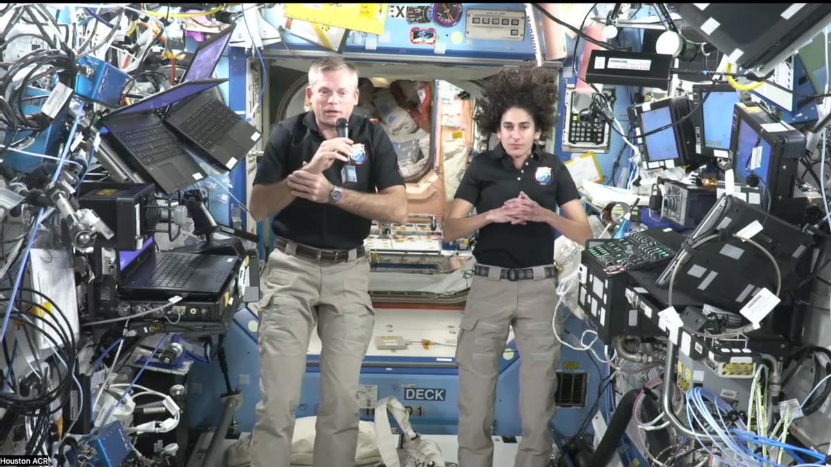 Andreas Mogensen (L) and Jasmin Moghbel (R) float while aboard the International Space Station