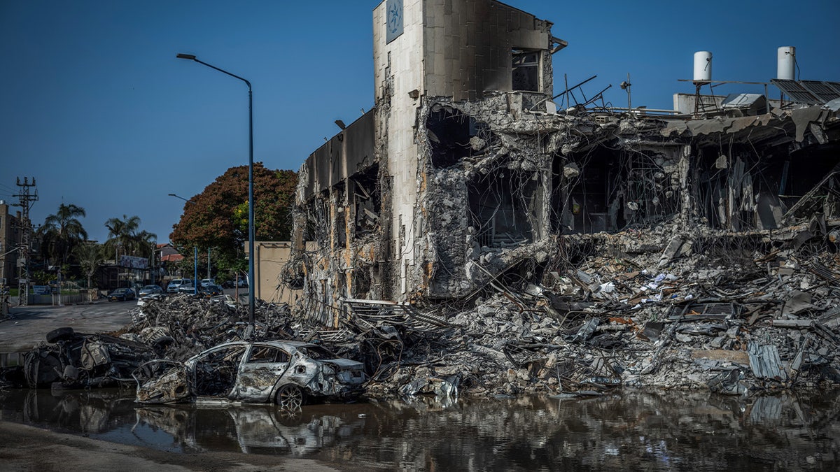 Crumbled building and burnt car in Sderot, Israel