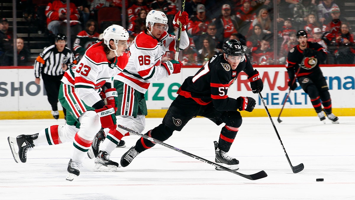 Shane Pinto chases the puck