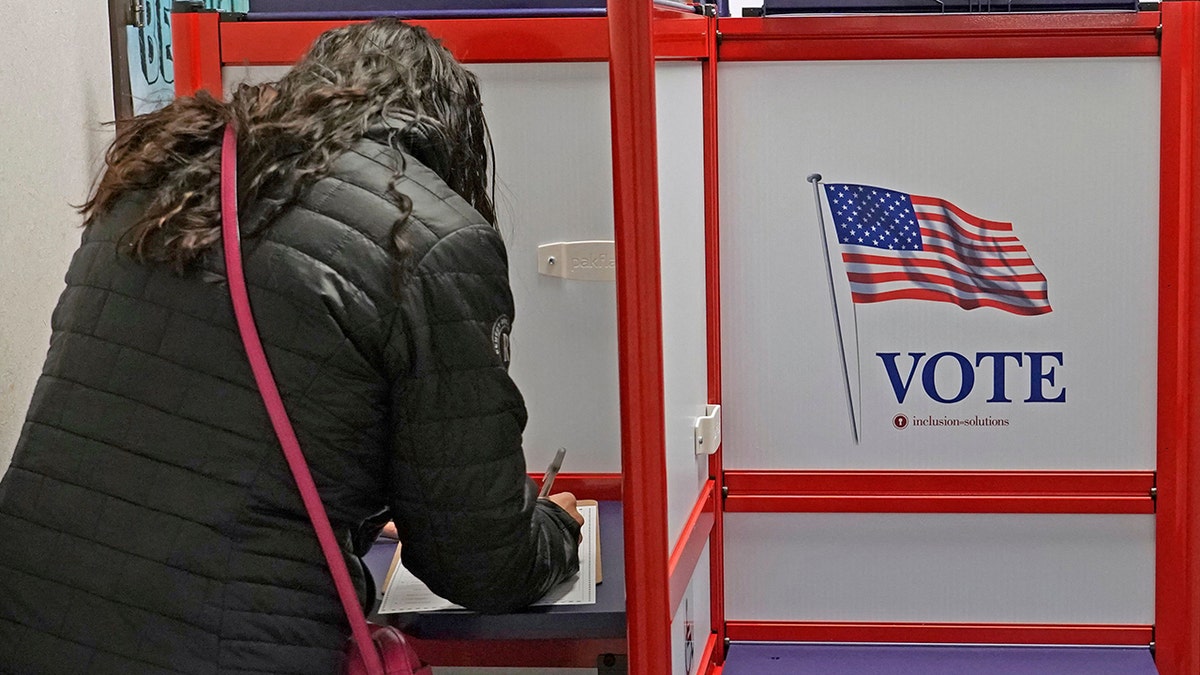 Woman voting at ballot box