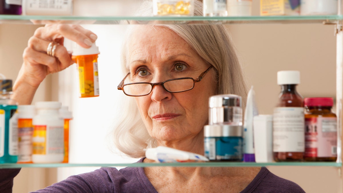 Woman at medicine cabinet