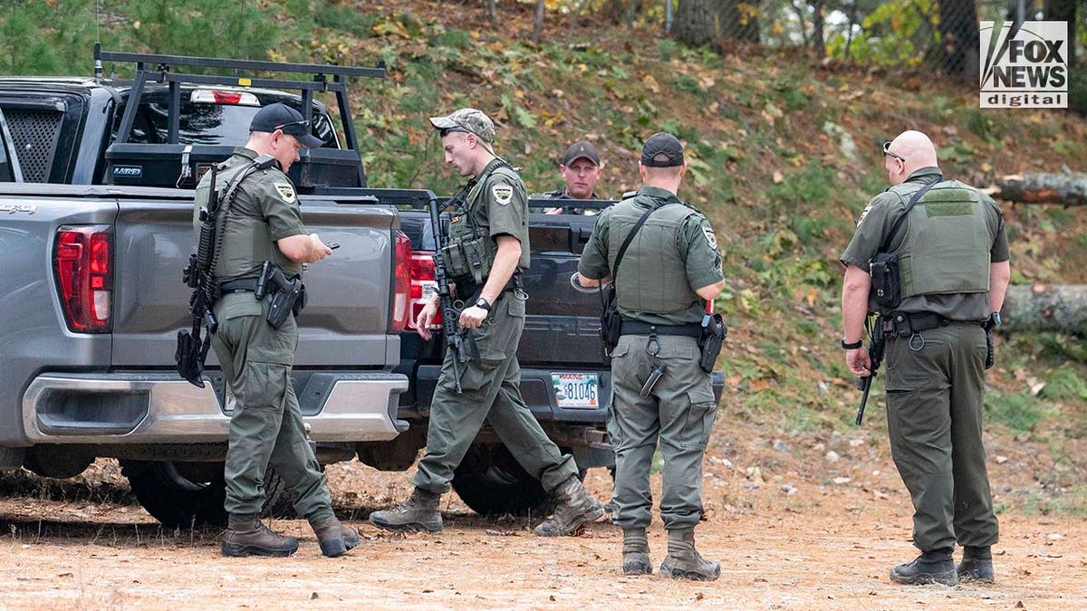 Law enforcement agents aid in the search for Robert Card along the Androscoggin River