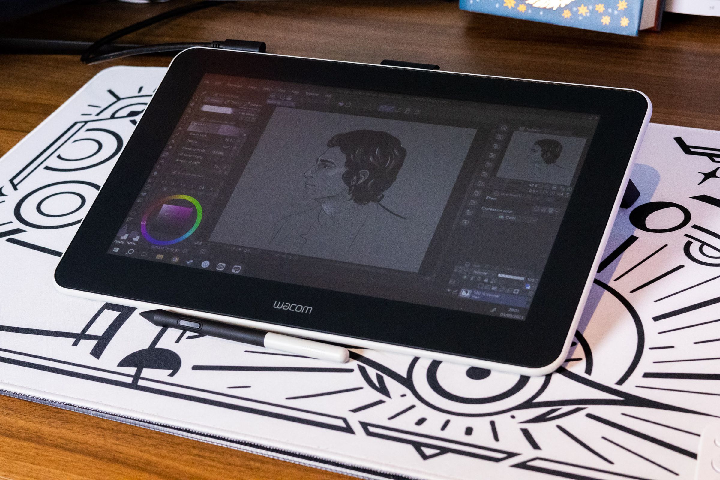 The Wacom One (2019) display tablet on a white desk pad.