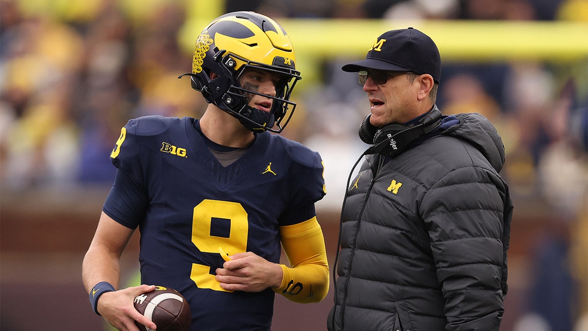 Jim Harbaugh talks with J.J. McCarthy