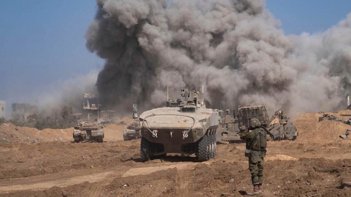 heavy smoke in background, tanks in foreground in Gaza