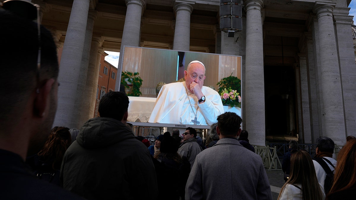 The pope coughing on a screen