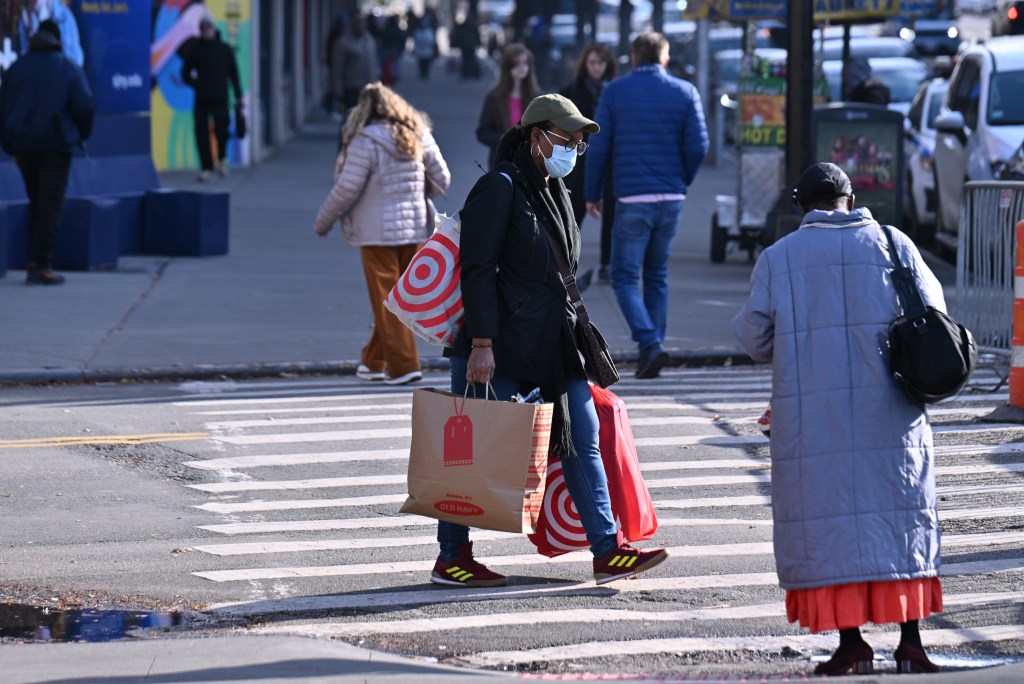A woman carrying shopping bags in NYC. 