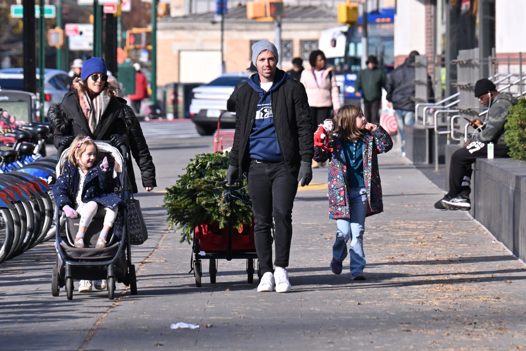 A man buying a Christmas tree in NYC.