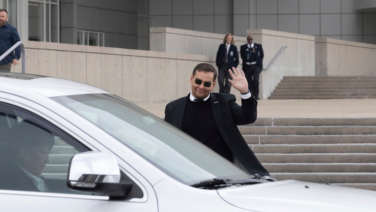 George Santos waves to reporters outside federal NY courthouse