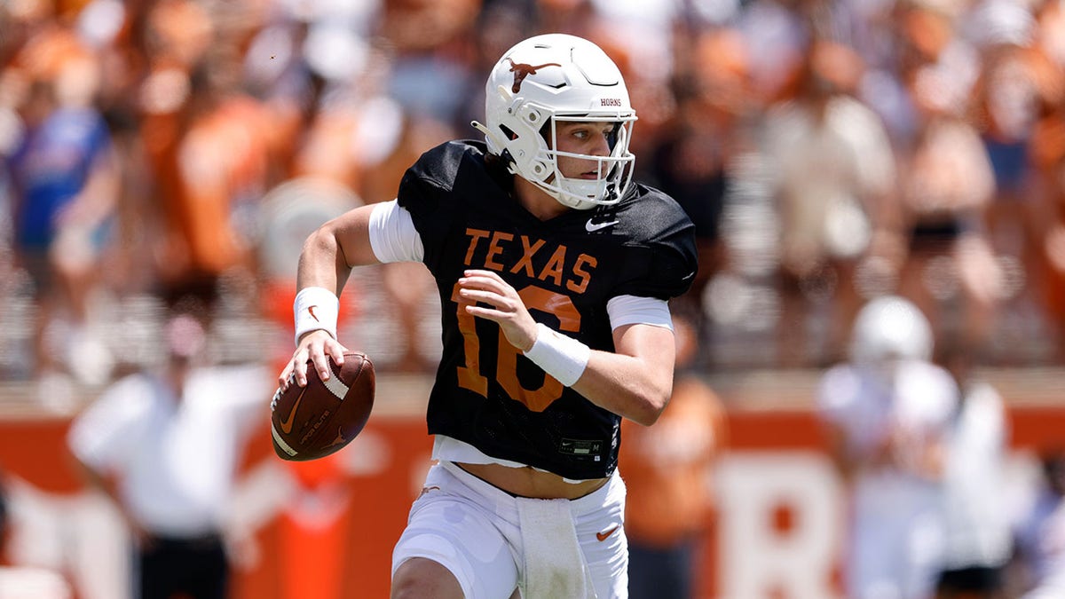 Arch Manning scrambles during a spring game