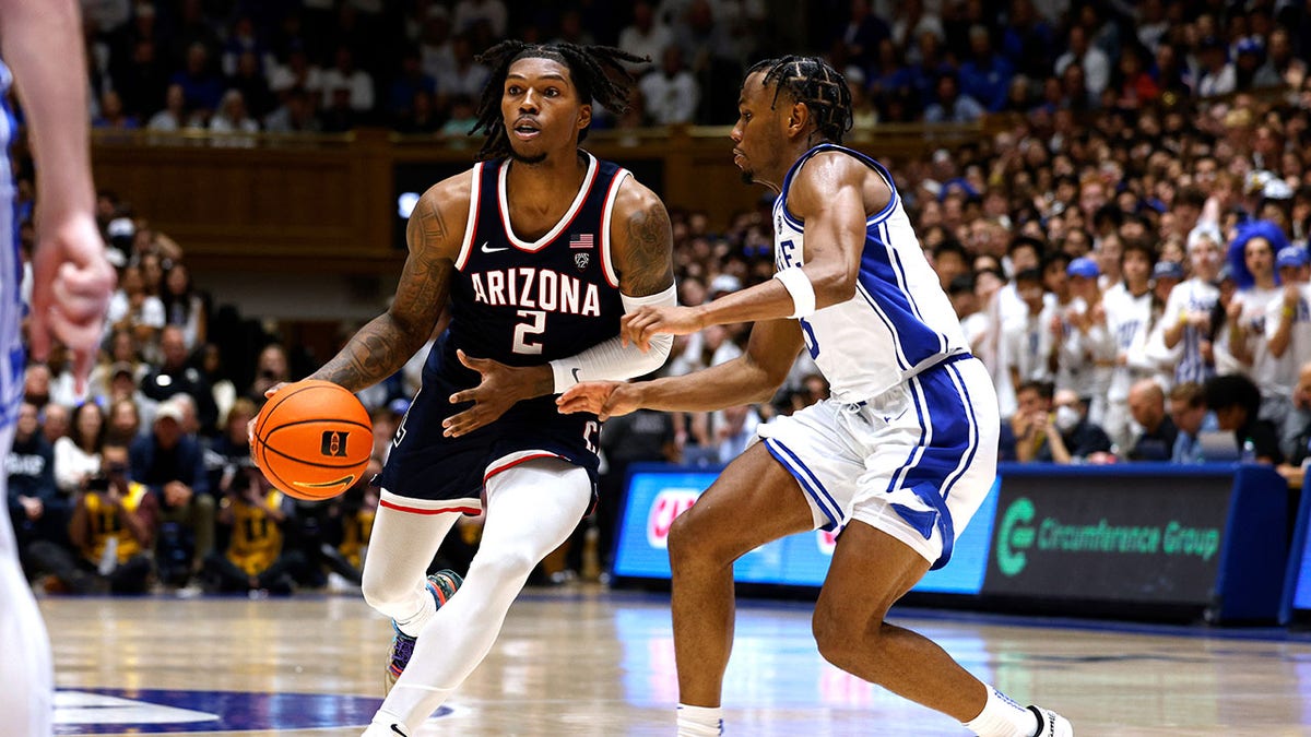 Caleb Love dribbles during a game against Duke