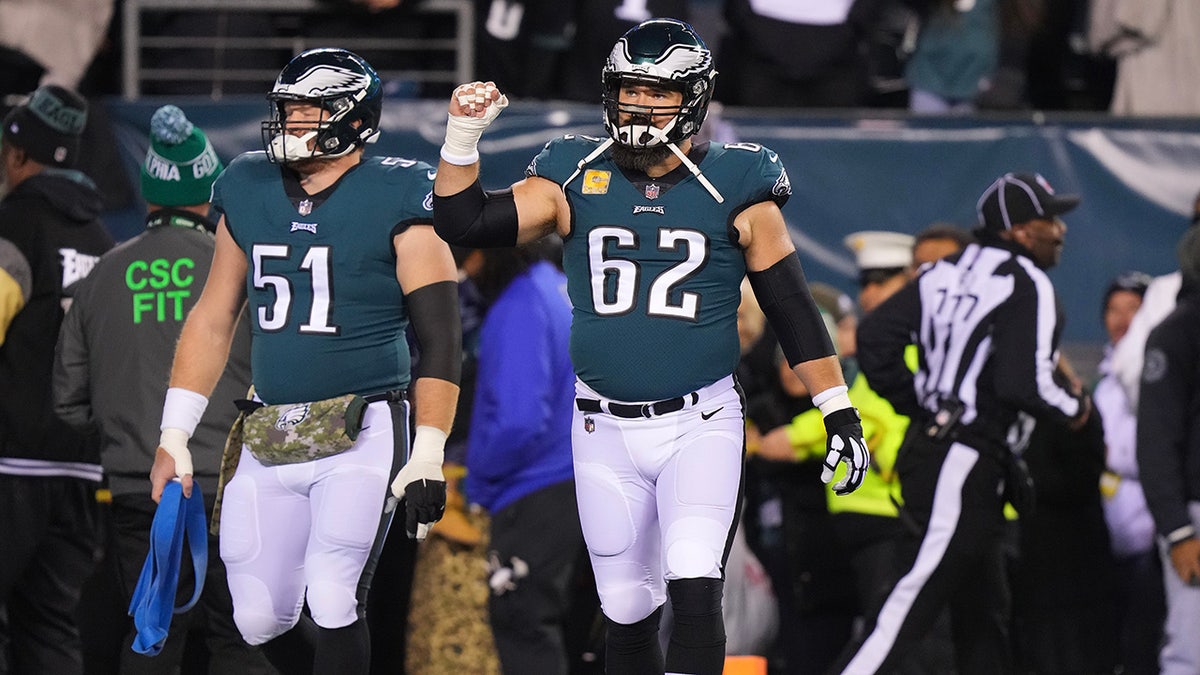 Cam Jurgens and Jason Kelce walk on the football field