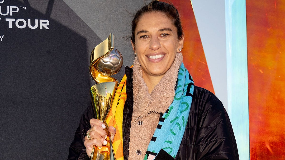 Carli Lloyd poses with World Cup trophy