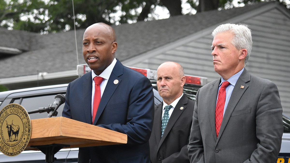 Harrison standing at a podium