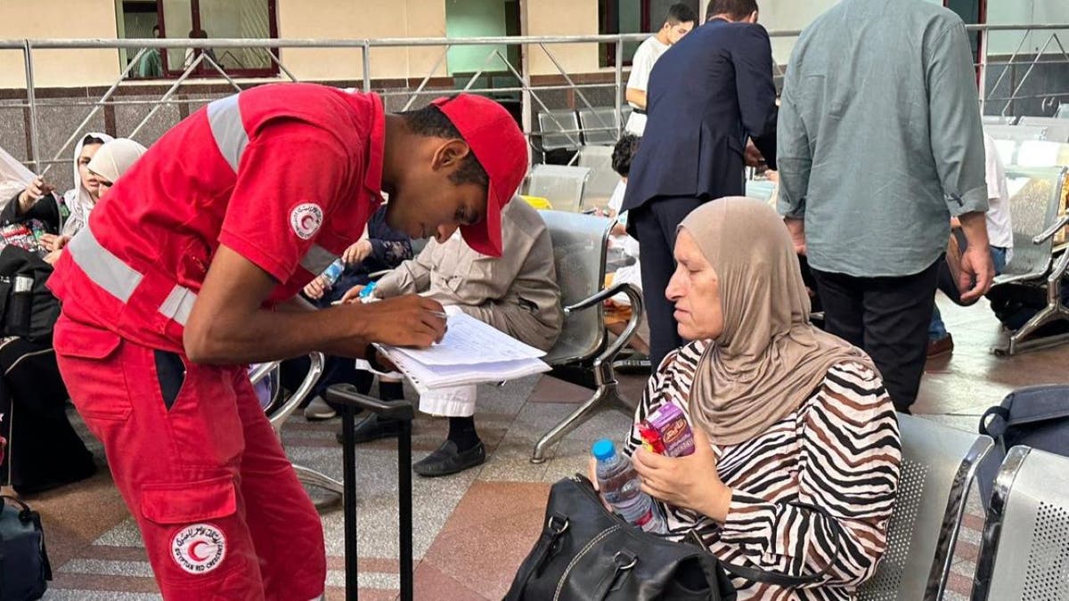 Egyptian official speaking to refugee