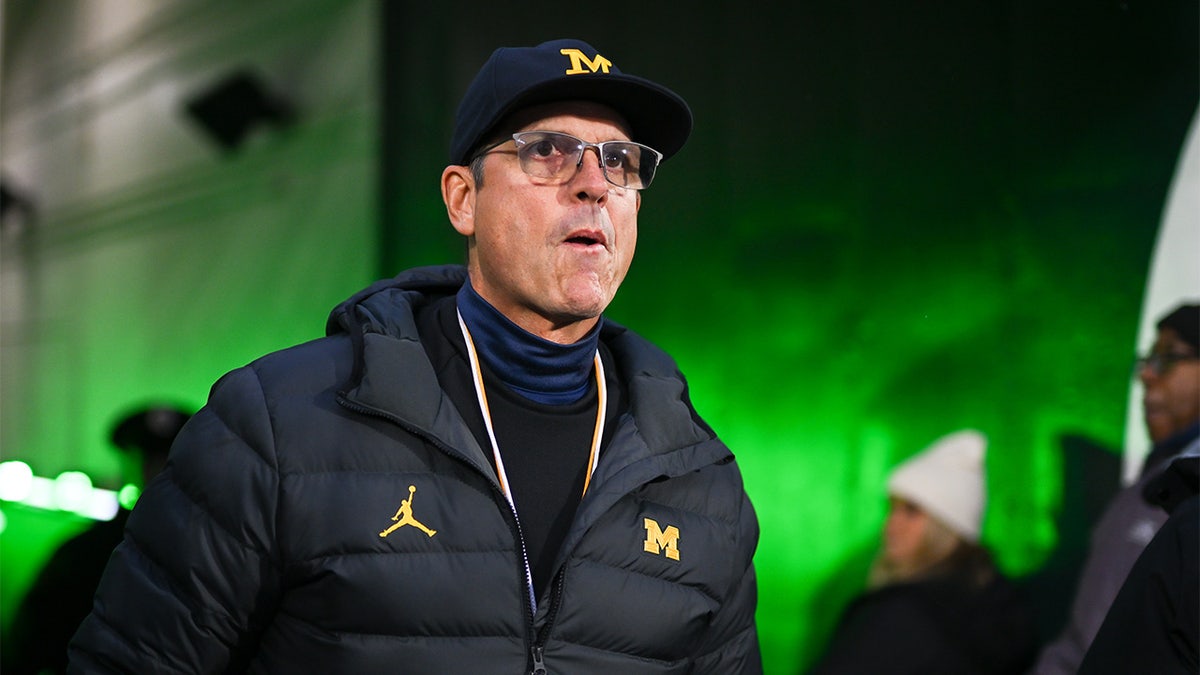 Jim Harbaugh walks onto the field