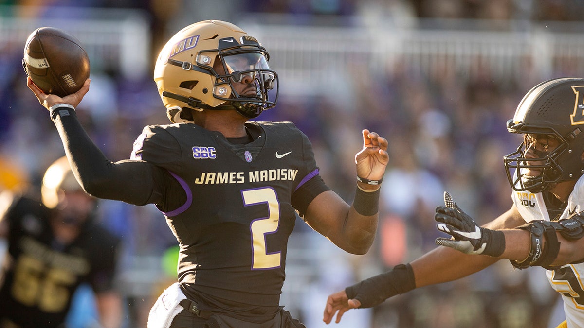 James Madison quarterback throws the football