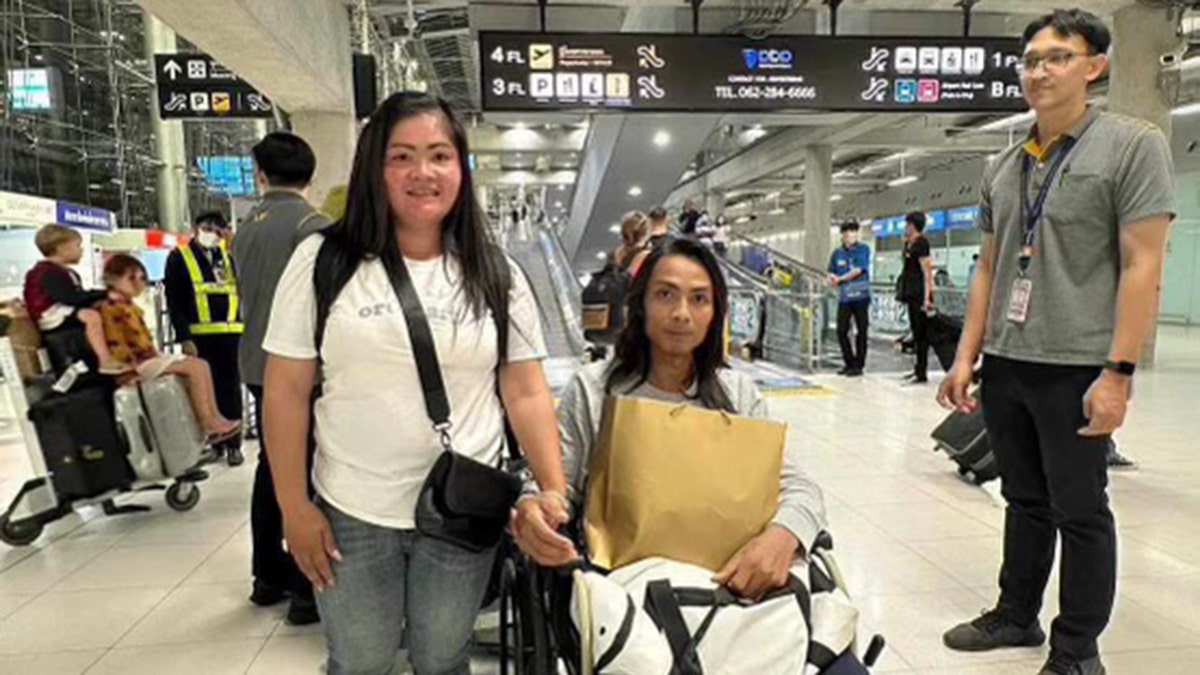 Mitchai Sarabon in an airport in a wheelchair