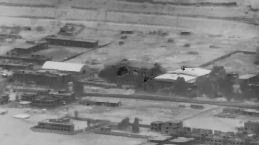 This image from video provided by the Department of Defense shows a Nov. 8, 2023, airstrike on a weapons warehouse, center, in eastern Syria.