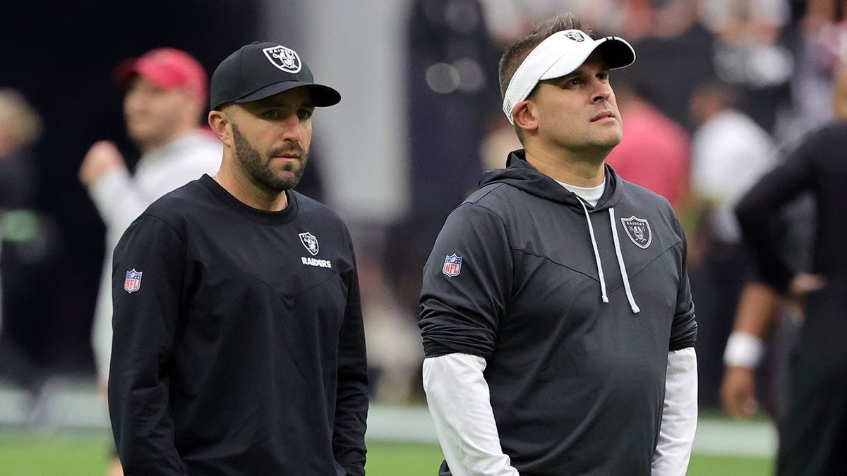 Mick Lombardi and Josh McDaniels stand together before a game