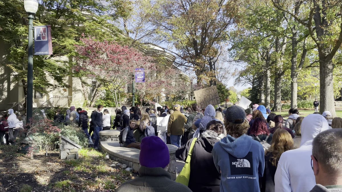 Students march with signs during the American University walkout for Gaza