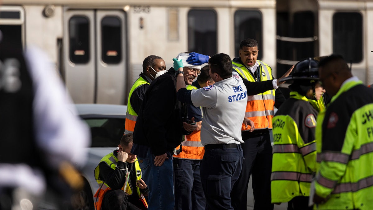 A man being treated by paramedics