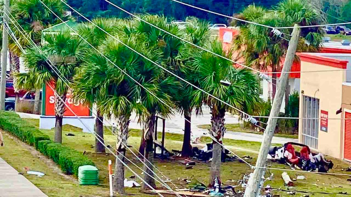 Corvette debris strewn across lawn