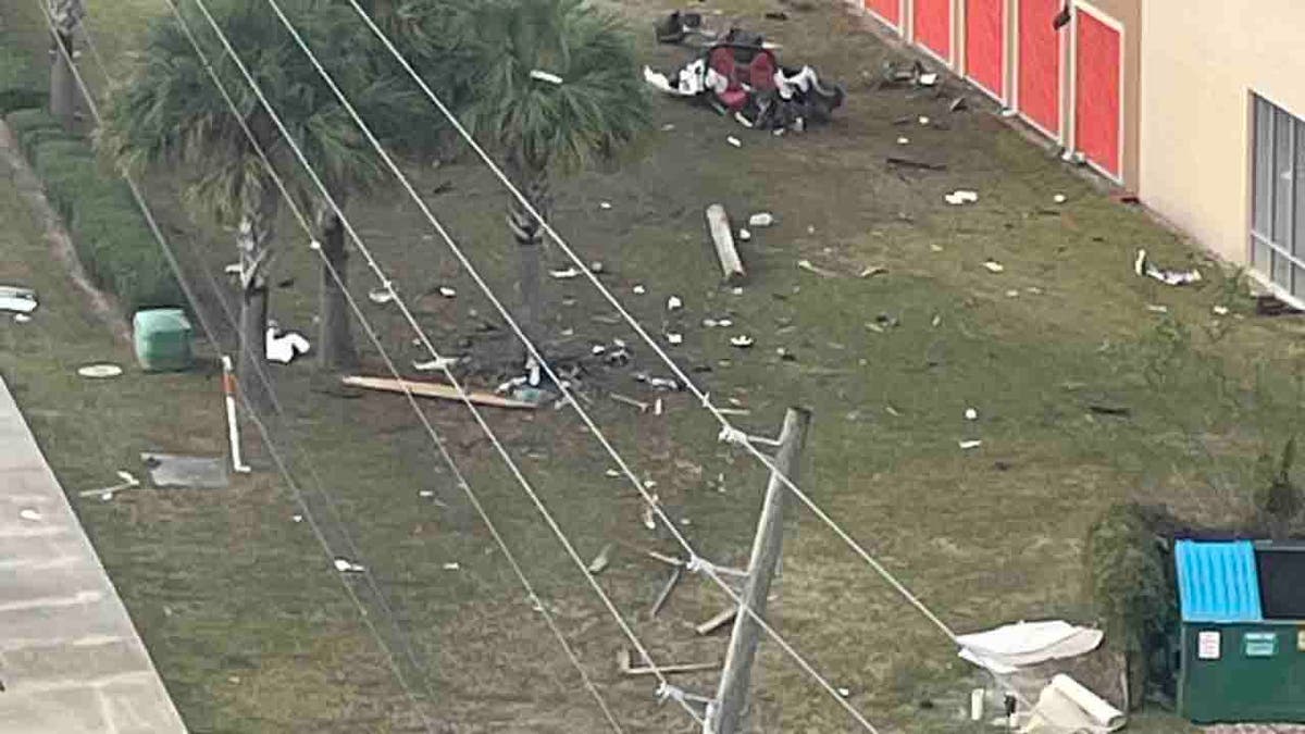 Corvette debris strewn across lawn