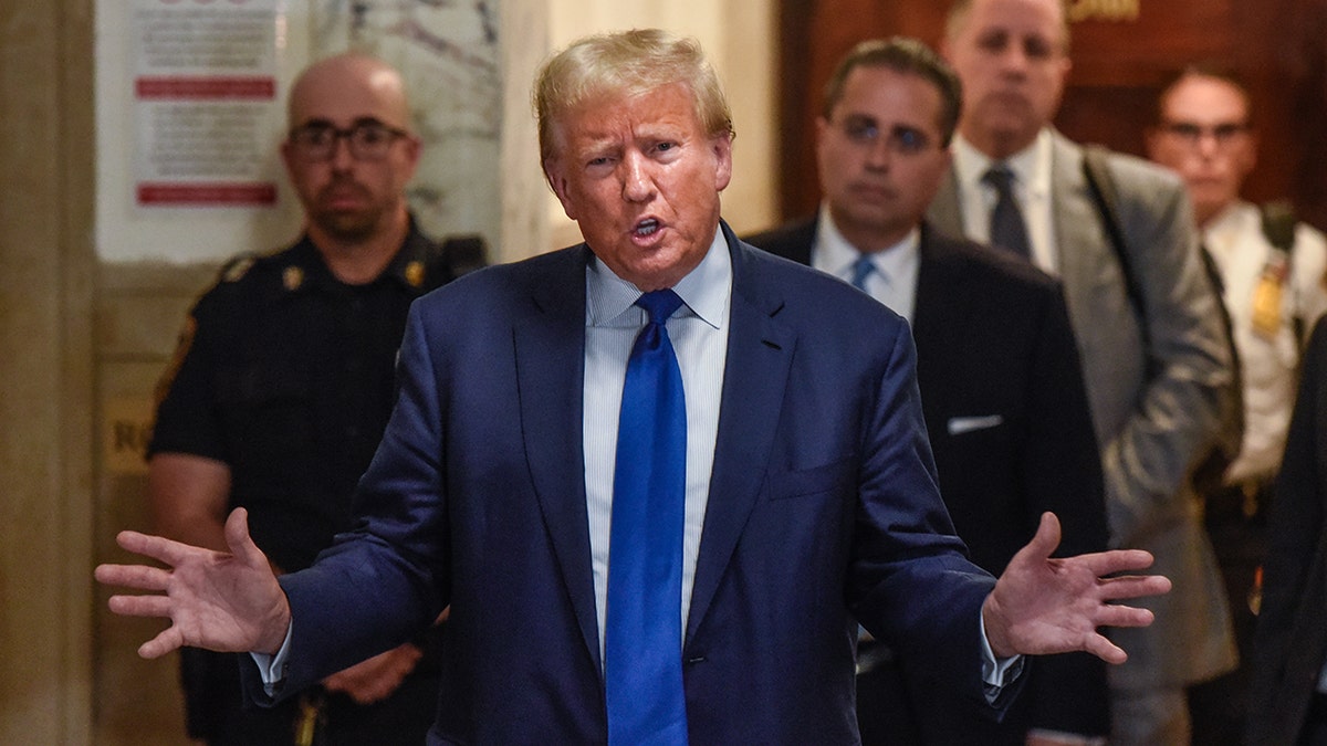 Former President Donald Trump talks to reporters outside of a New York court hosue