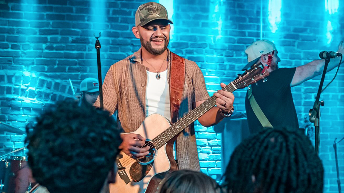 Frank Ray on stage with guitar