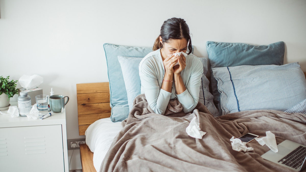 woman blowing nose