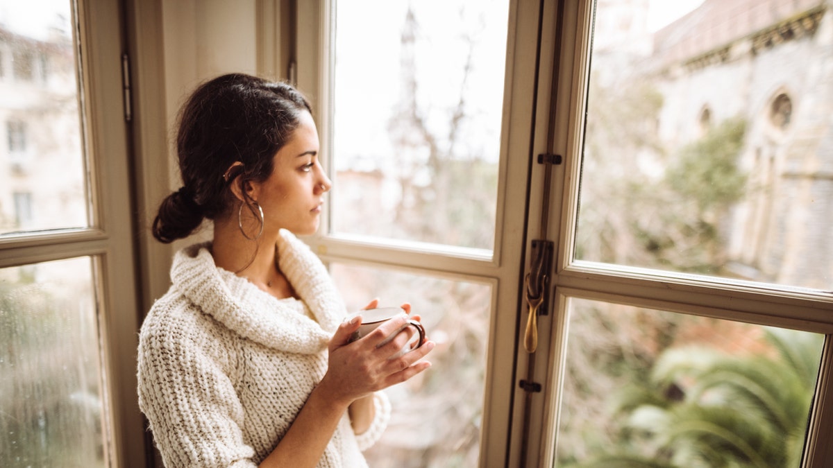 sad woman at window