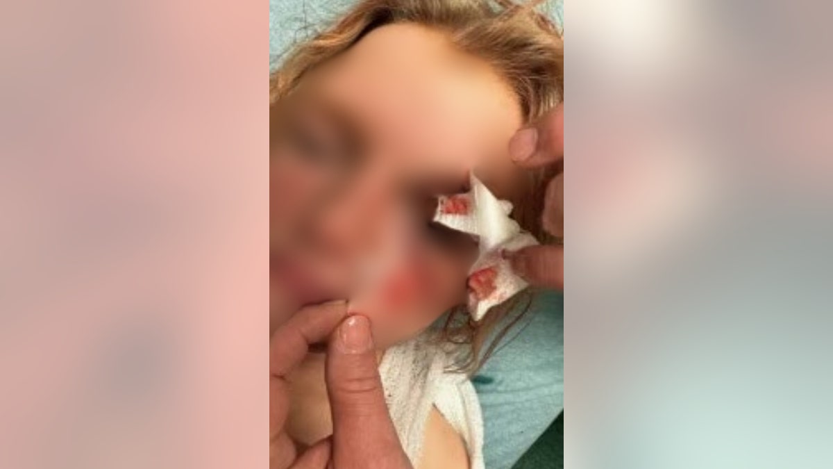 Ashley Wilson's daughter in the hospital with her face blurred