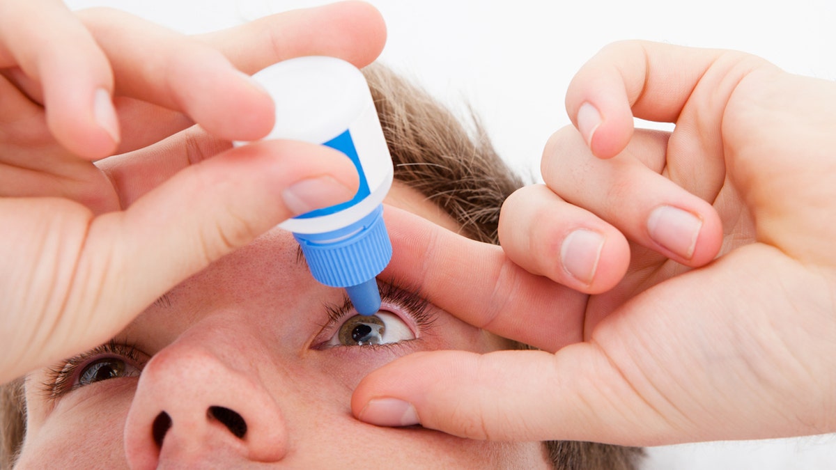 eye drops being used