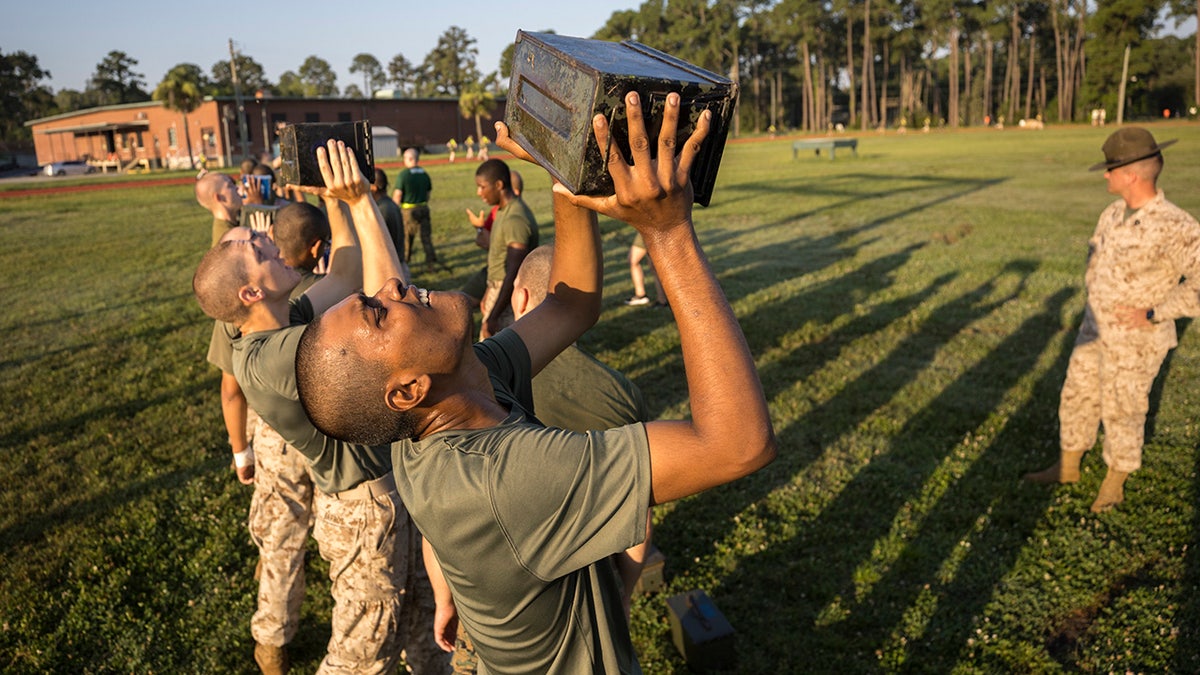 Marines carrying weighted ammo cans