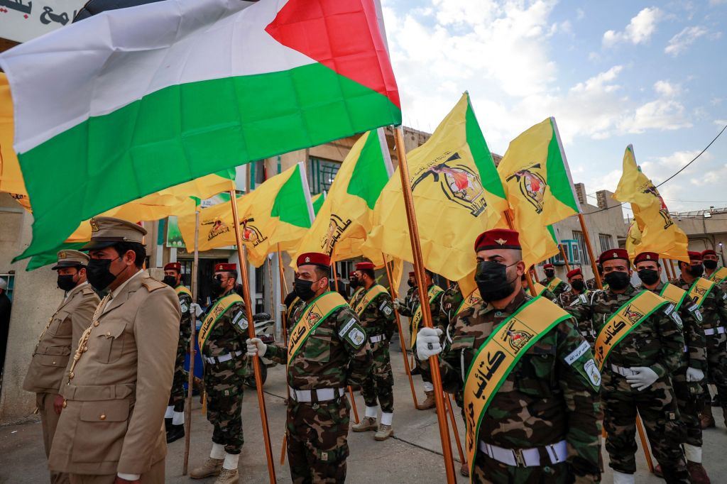 Members of the Hezbollah brigades, Kataeb Hezbollah, attend the funeral of Fadel al-Maksusi, a fighter who was also part of the "Islamic resistance in Iraq", the group that has claimed all recent attacks against US troops in Iraq and Syria, in Baghdad on November 21, 2023