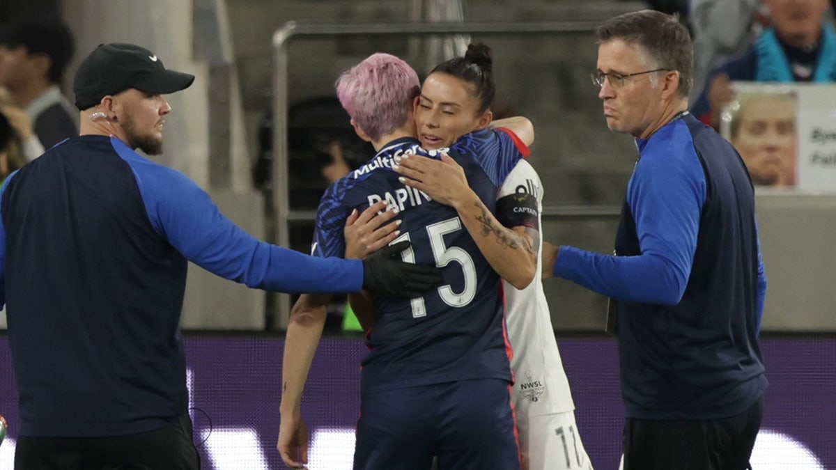 Megan Rapinoe hugs Ali Krieger