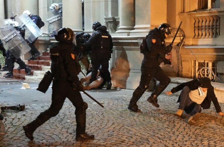 Serbian police fire tear gas at protesters threatening to storm city hall