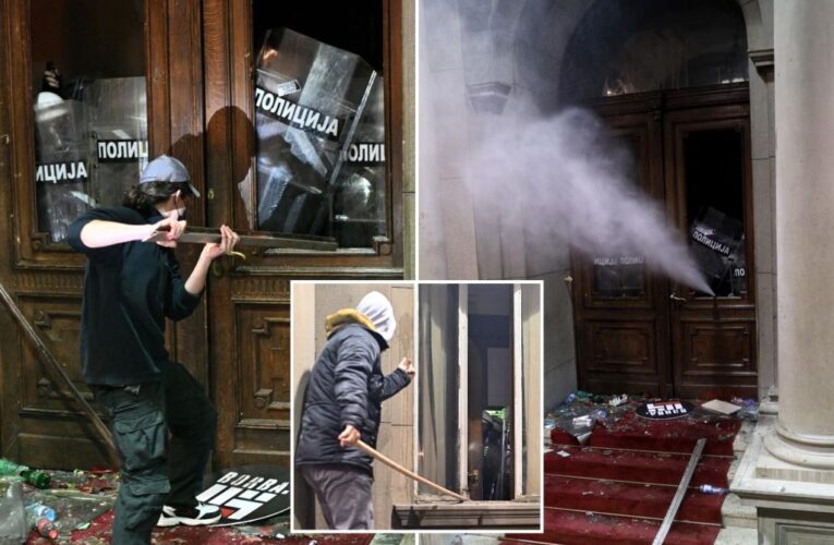 Serbia police fire tear gas at election protesters threatening to storm capital’s city hall
