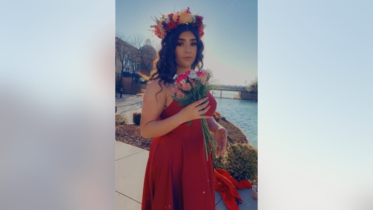 Lizbeth Medina wearing a dress and flower crown