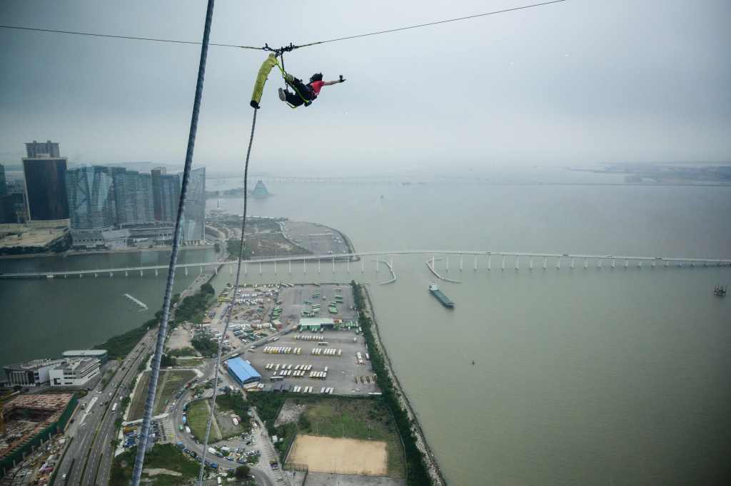 This picture taken on November 15, 2018 shows a person taking part in a 233meters / 764feet high bungee jump off the Macau Tower in Macau