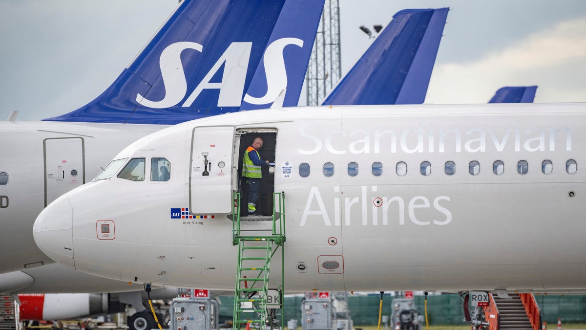 Worker on Scandinavian Airlines airplane