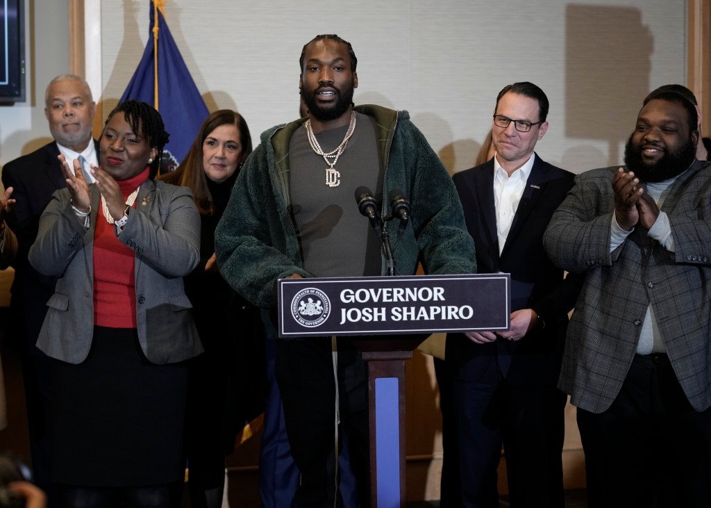 Rapper Meek Mill, center, speaks during a ceremonial bill-signing in Philadelphia, Friday, Dec. 15, 2023.