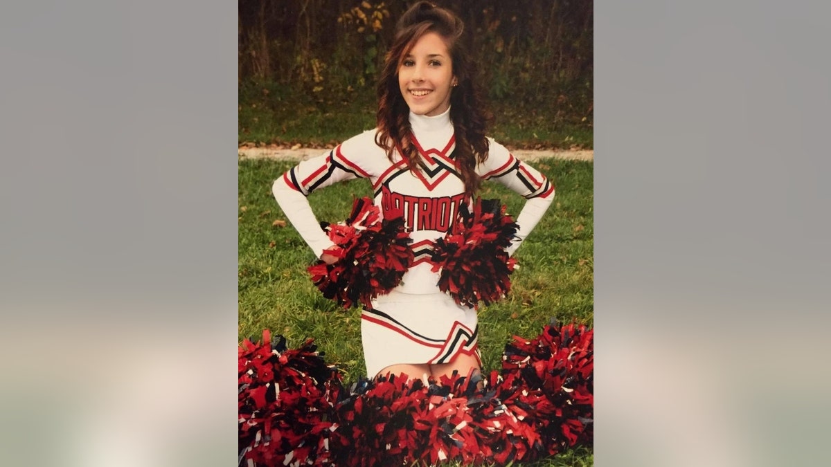 Libby Caswell in a cheerleading uniform