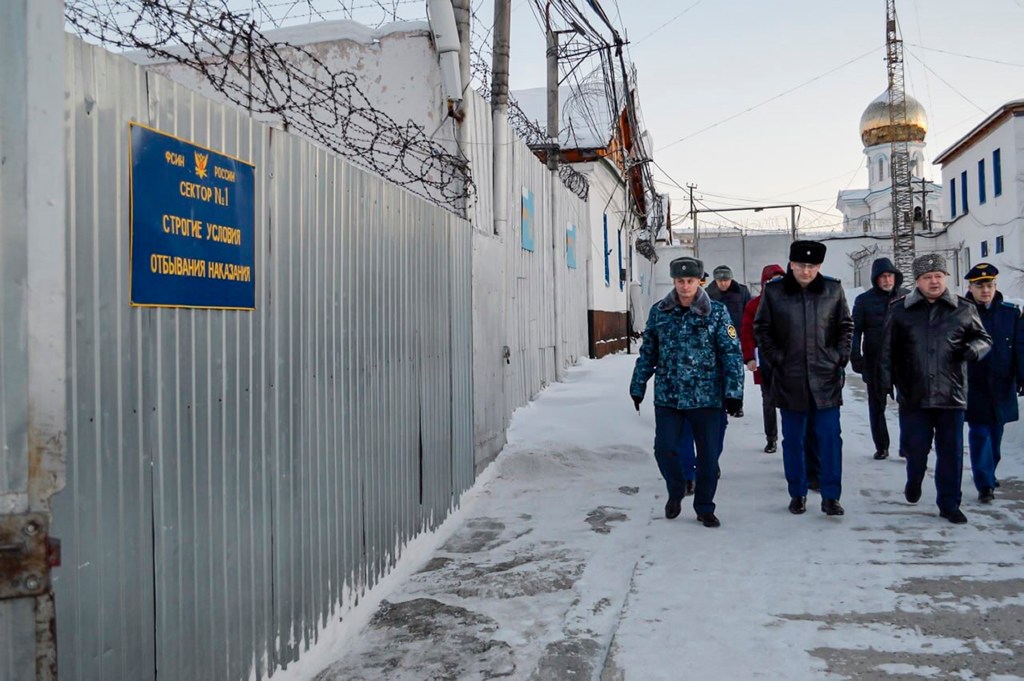 a group of officers walk inside a prison colony in the town of Kharp, in the Yamalo-Nenetsk region about 1,900 kilometers (1,200 miles) northeast of Moscow.