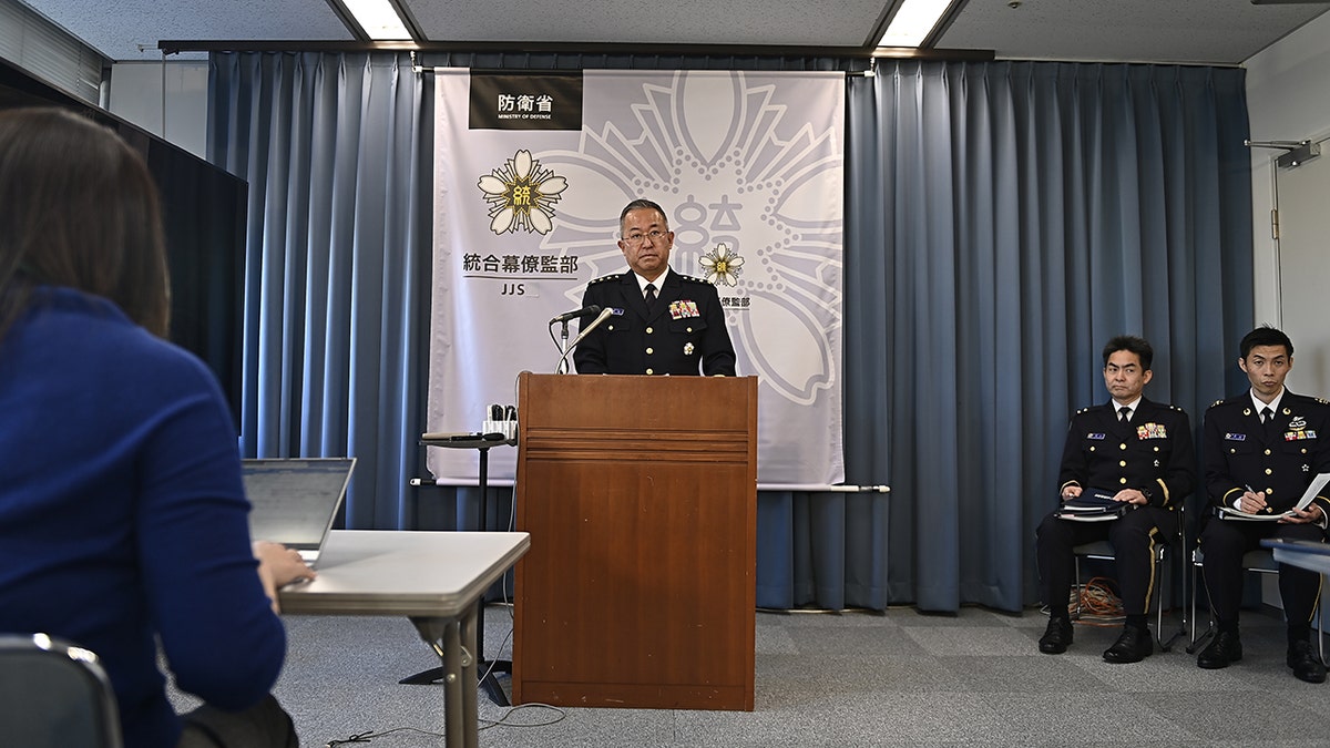 Yoshihide Yoshida speaking at podium