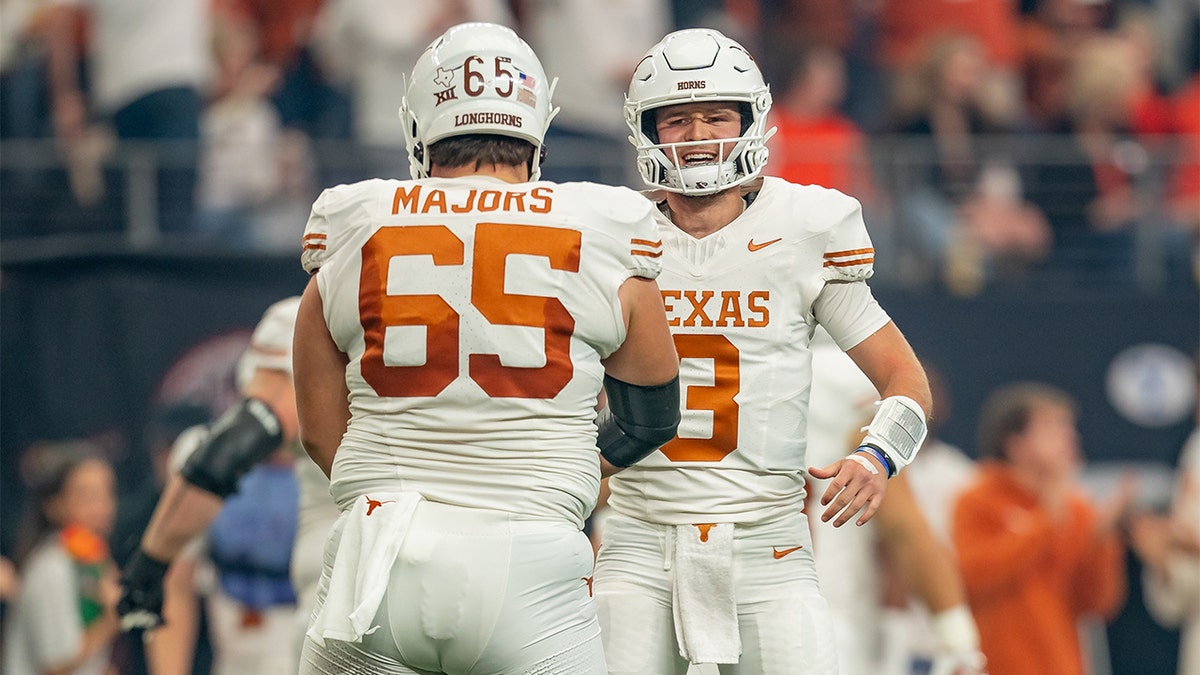 Quinn Ewers celebrates a touchdown