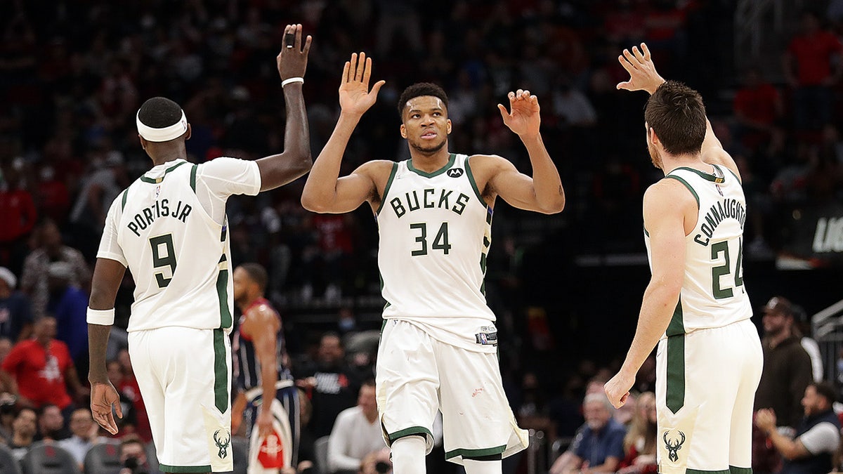 Giannis Antetokounmpo receives high fives