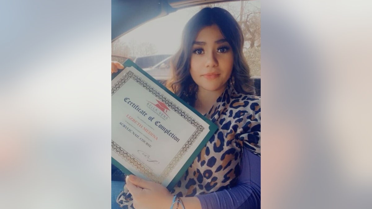 Lizbeth Medina holding a certificate