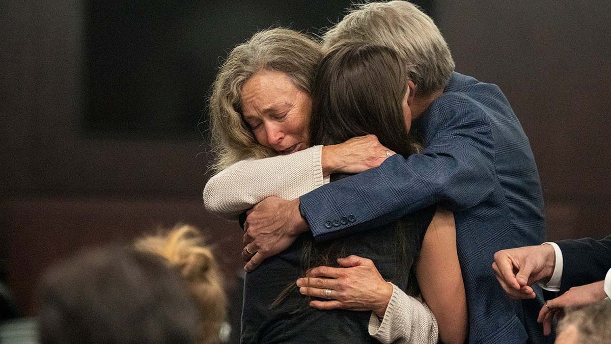 Karen Wilson and Eric Wilson, embrace Caitlin Cash